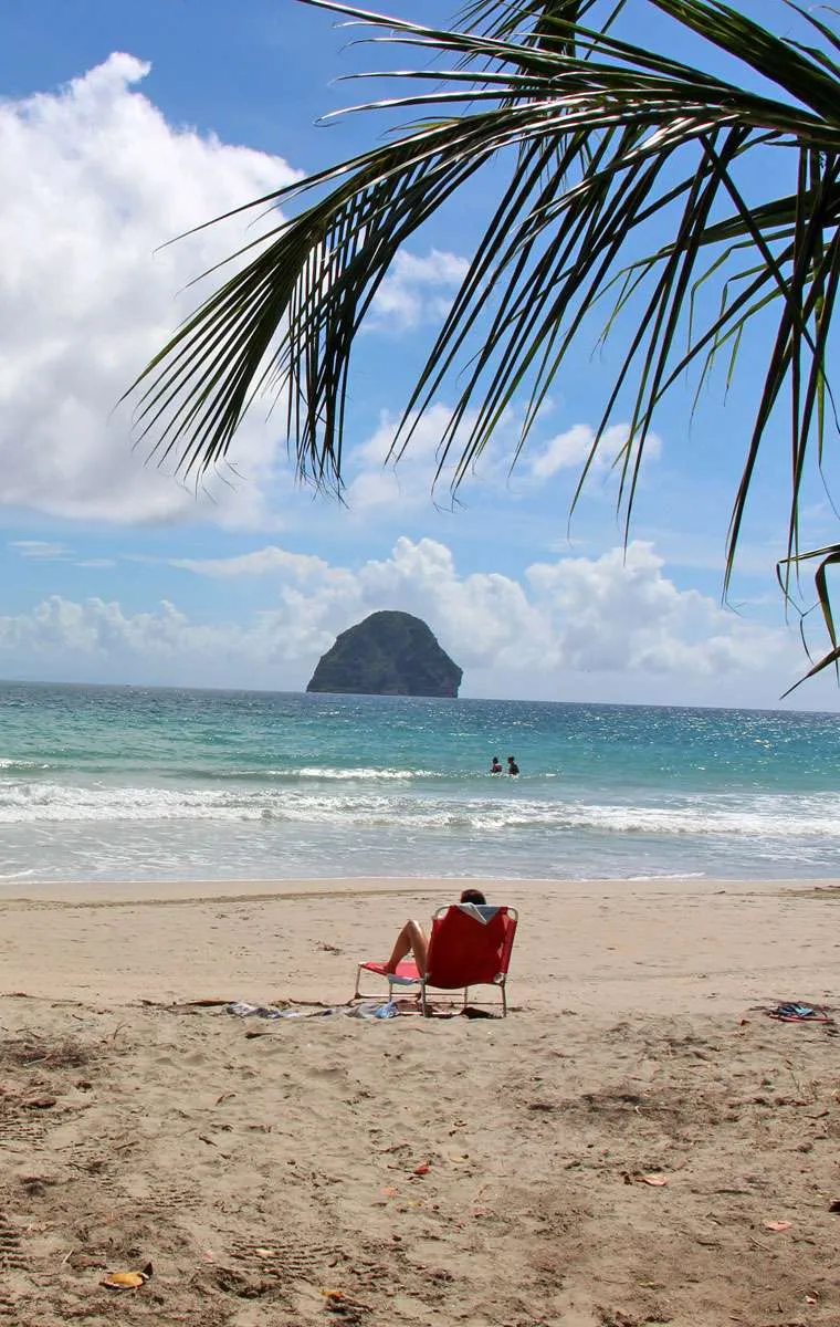 Person on a red chair in front of Diamond Rock