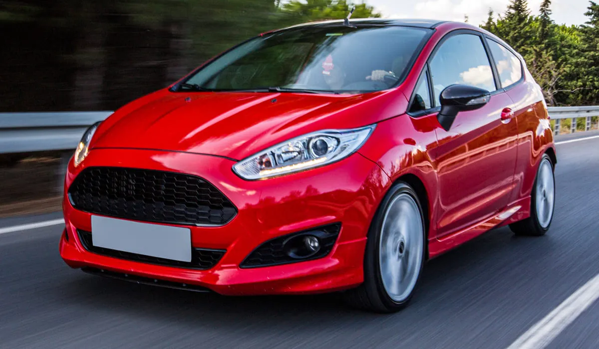 Red rental car on a road Red rental car on a road